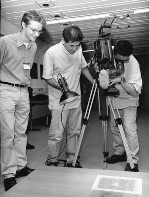 three gentlement with a camera